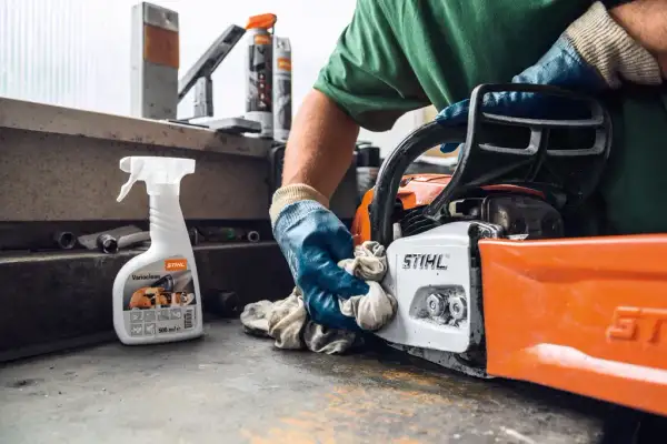Technician servicing outdoor power tools in a STIHL-certified workshop
