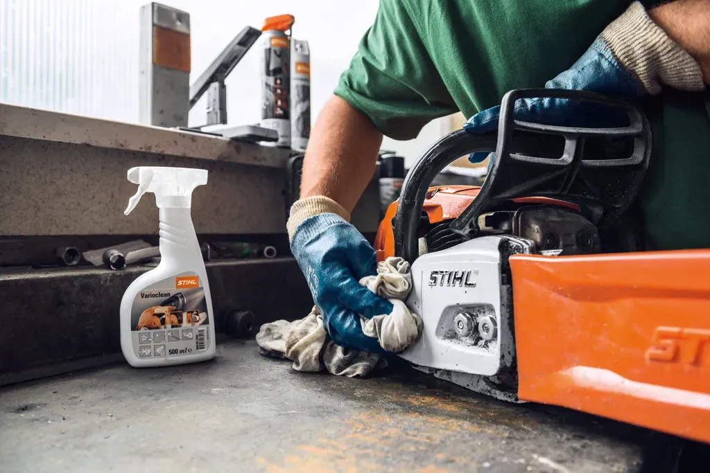 Technician servicing outdoor power tools in a STIHL-certified workshop